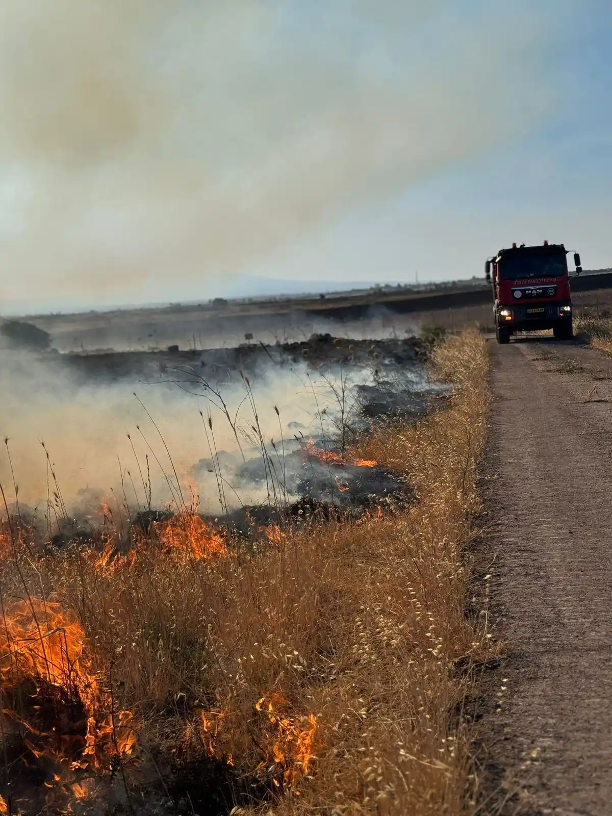 Image from Quds News Network: Fires erupt in the occupied Golan heights after the fall of intercepto...