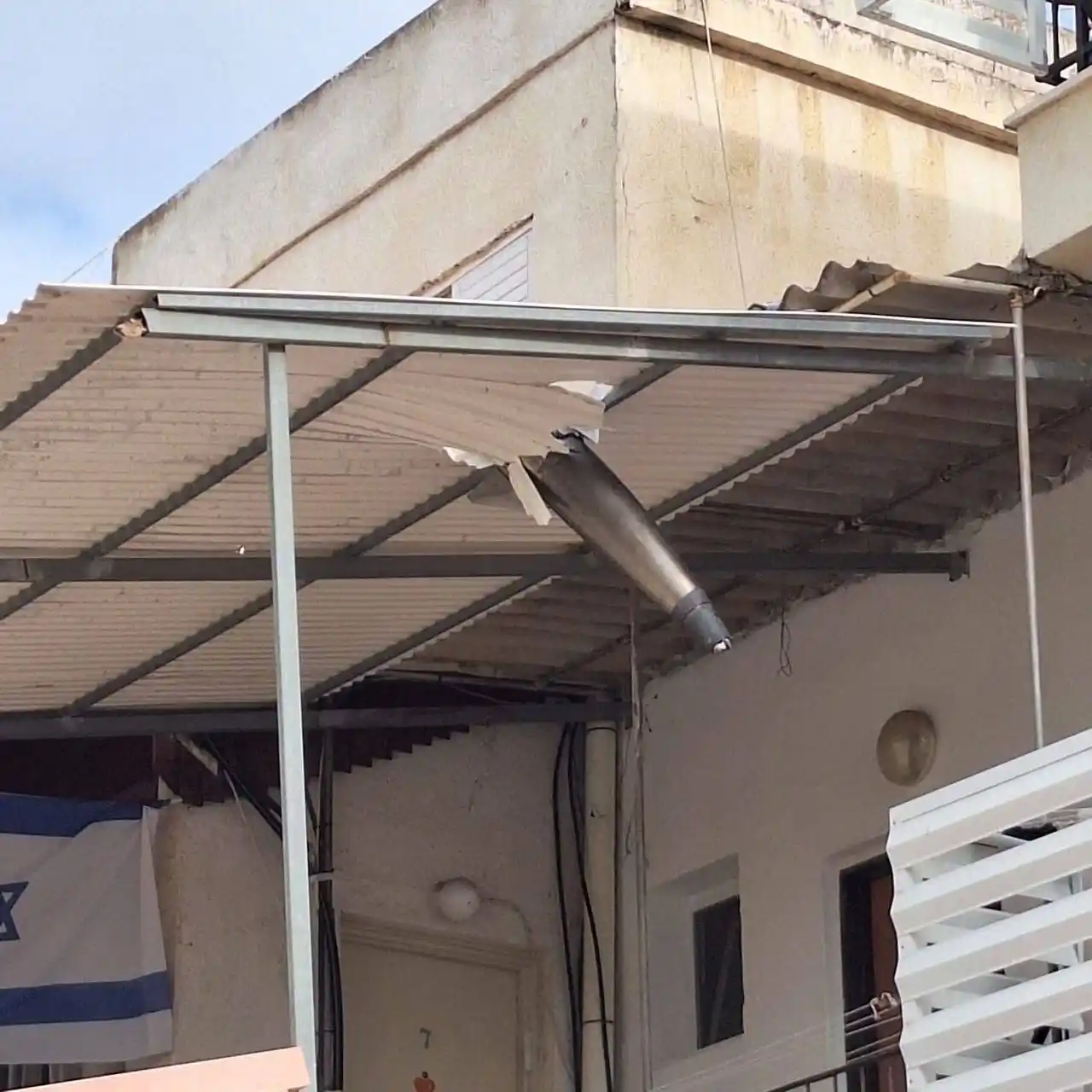 Image from Quds News Network: An Israeli interceptor missile fell on a settler's home after failing ...