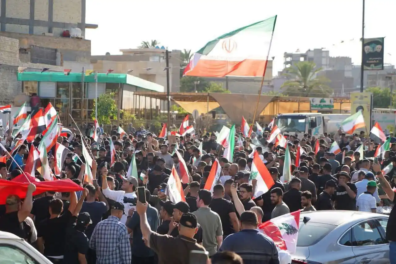 Image from Quds News Network: Hundreds marched today in the Kadhimiya district of Baghdad in support...